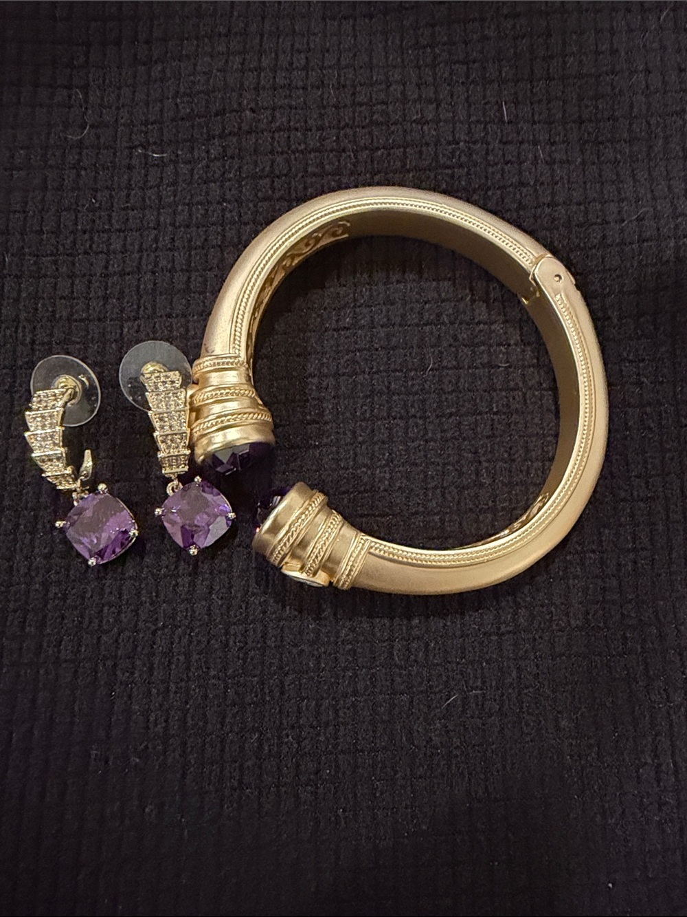 Matching gold tone and amethyst bracelet and earrings.